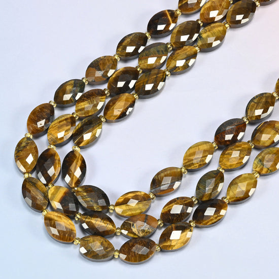 Tiger eye faceted flat oval beads in several strands curved into a wide U, golden brown and honey stone