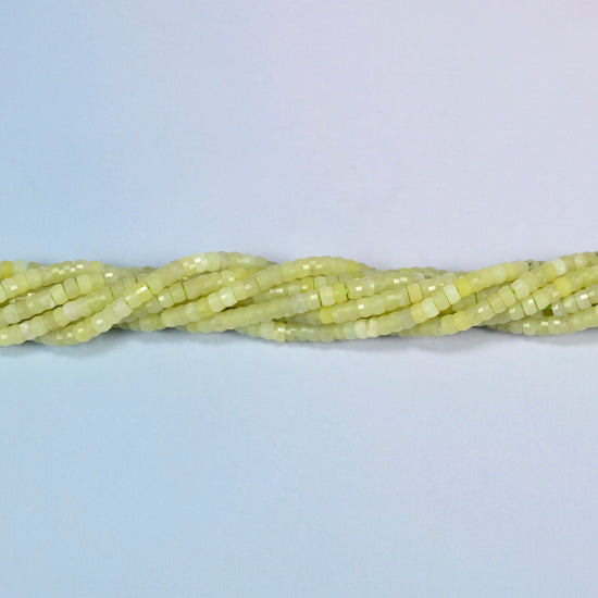 Strands of Lemon Jade faceted heishi disc beads twisted together in a horizontal row