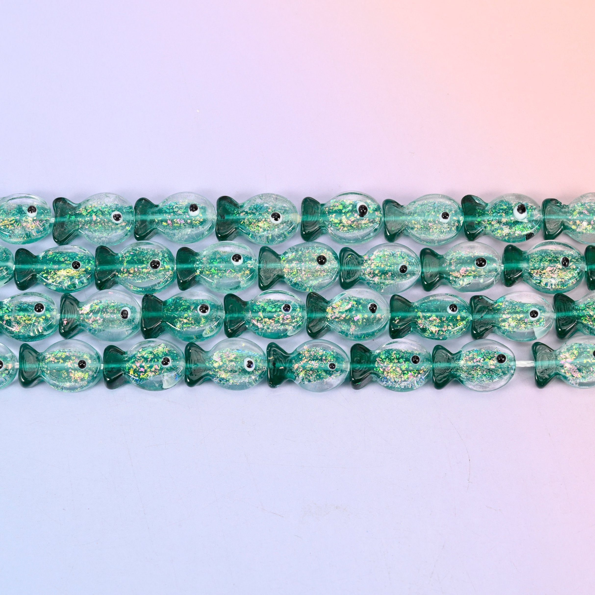 Iridescent Green Fish Glass Beads in sea green with gold glitter