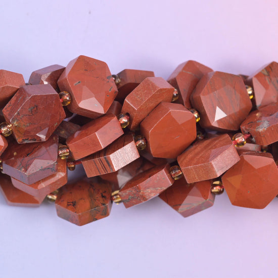 Flat faceted hexagon cut Red Jasper beads with facets radiating from a raised centre point