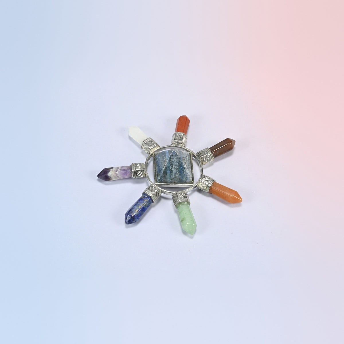 Crystal energy generator with a blue lapis lazuli center pyramid and seven chakra crystal points in a silver-tone frame