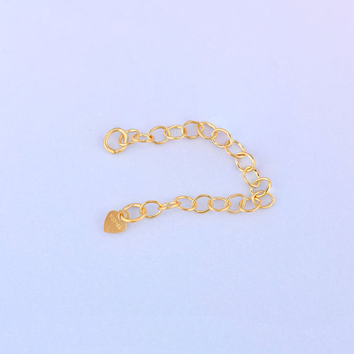 14K gold filled heart chain extender curved gently, showing the heart charm stamped 1/20 14K near the jump ring end.