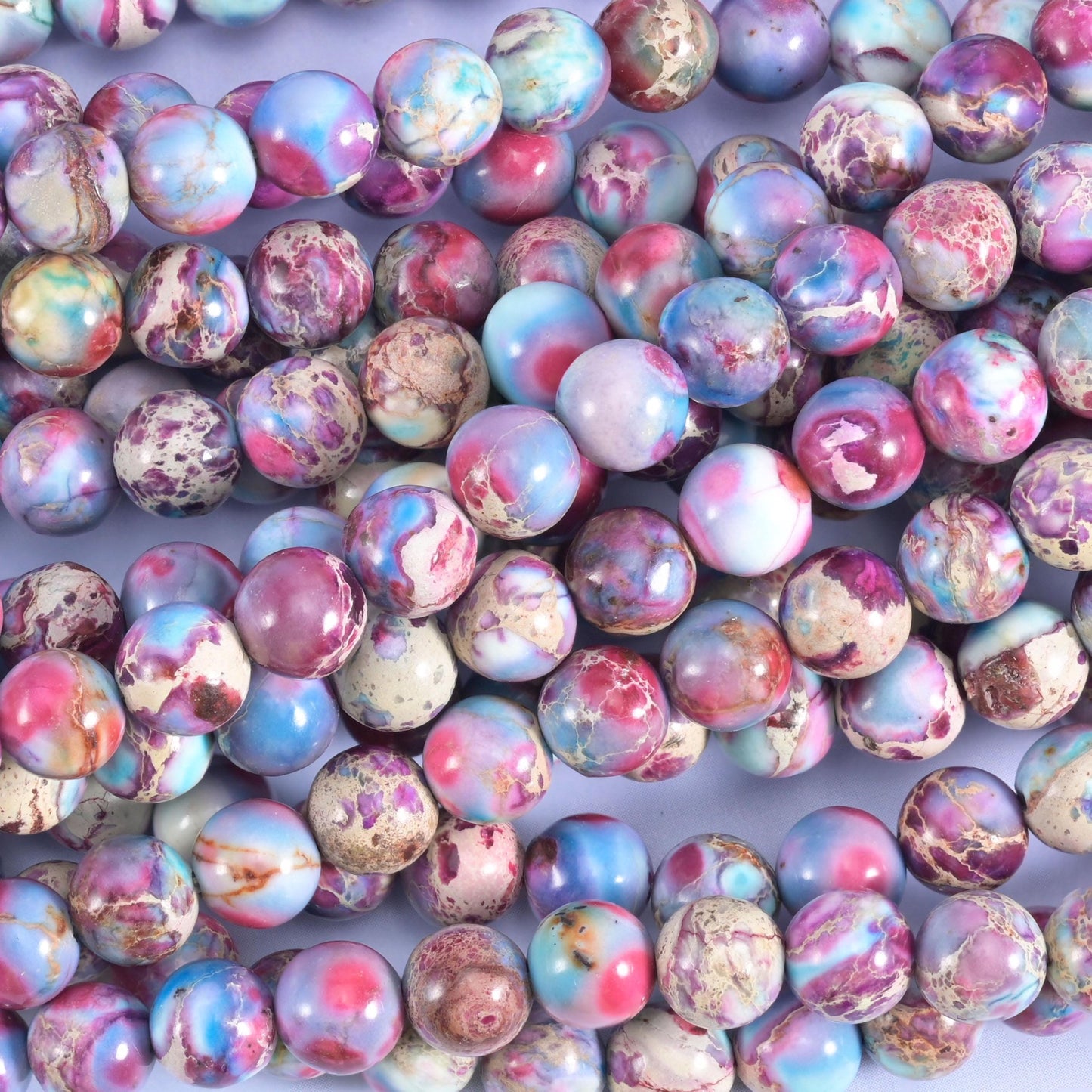 Bright rose pink, sky blue and lavender marbled over a sandy cream base, colour-enhanced with dark mineral speckling