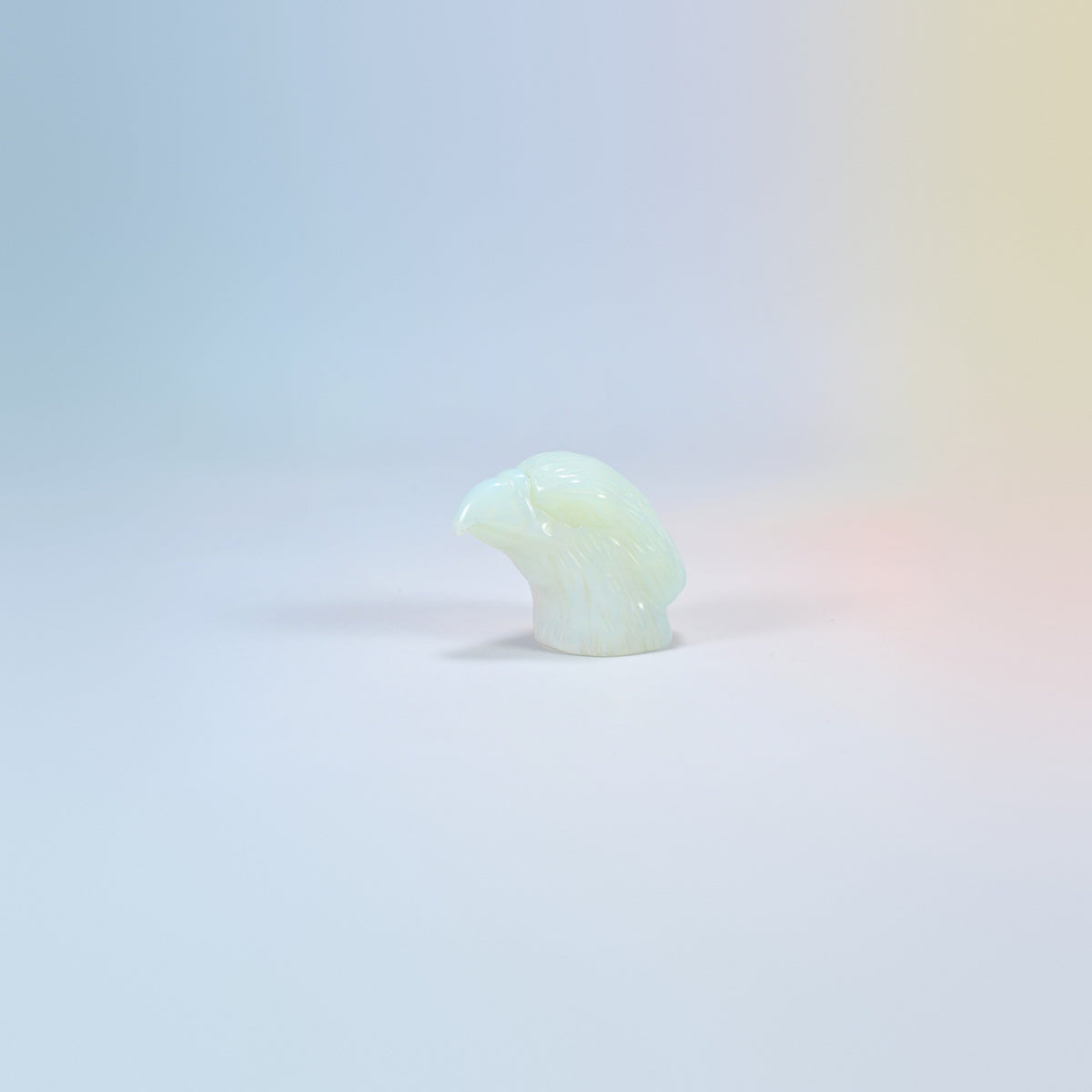 2 inch opalite eagle head carving, milky man-made glass with a soft glow