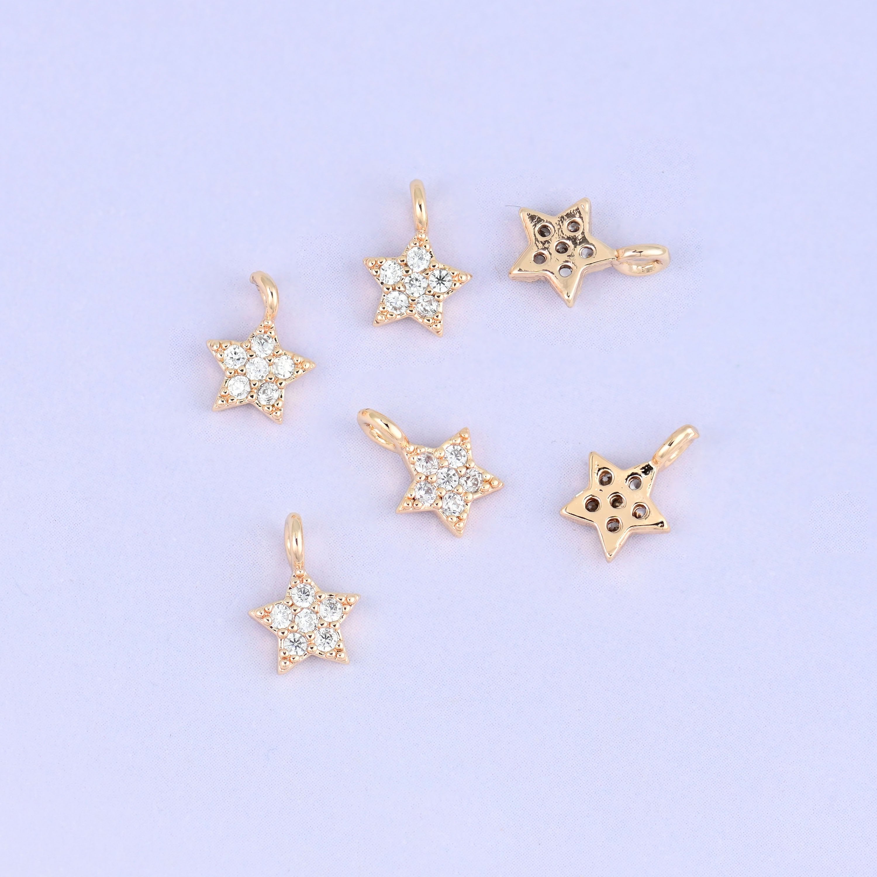 Small gold charms, seven star charms with two turned to show the plain back