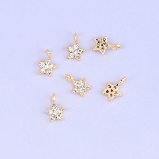 Small gold charms, seven star charms with two turned to show the plain back
