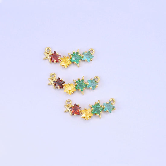 Four star-cut zircons in garnet red, lemon yellow, mint green and aqua, claw set along a gold bar