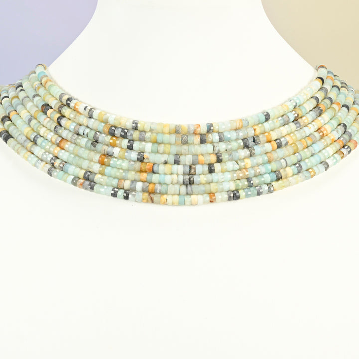 Multi-color amazonite faceted heishi disc strands arranged as a layered collar on a white display bust, blue-green and cream beads across the neck