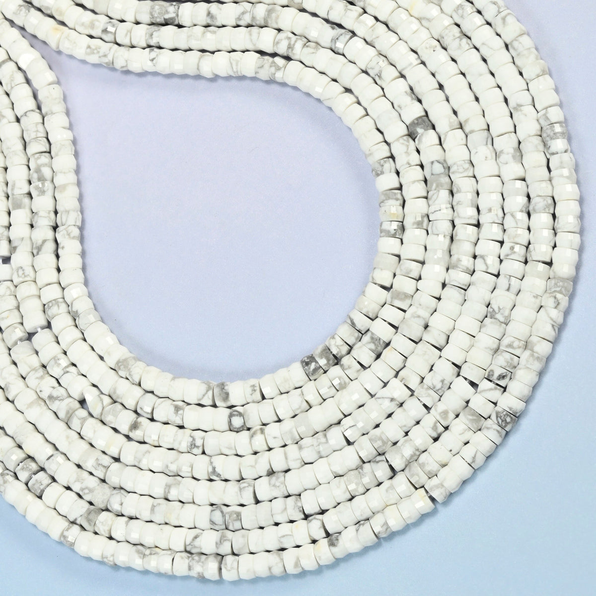 White howlite faceted heishi disc beads curved into an open loop, white and gray beads