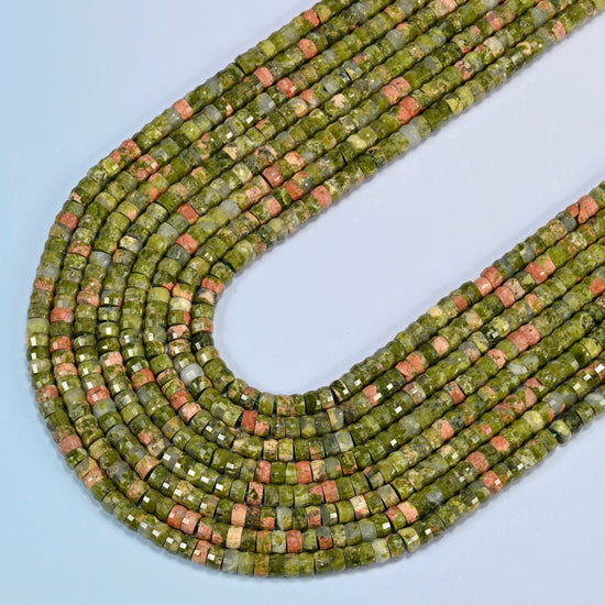 Unakite faceted heishi disc beads in several strands curved into a wide U, olive green stone with pink patches