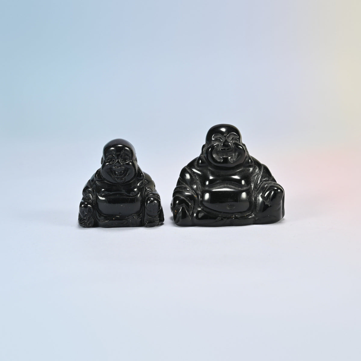 A 1.5 inch and a 2 inch black obsidian laughing Buddha crystal carving, glossy black natural stone
