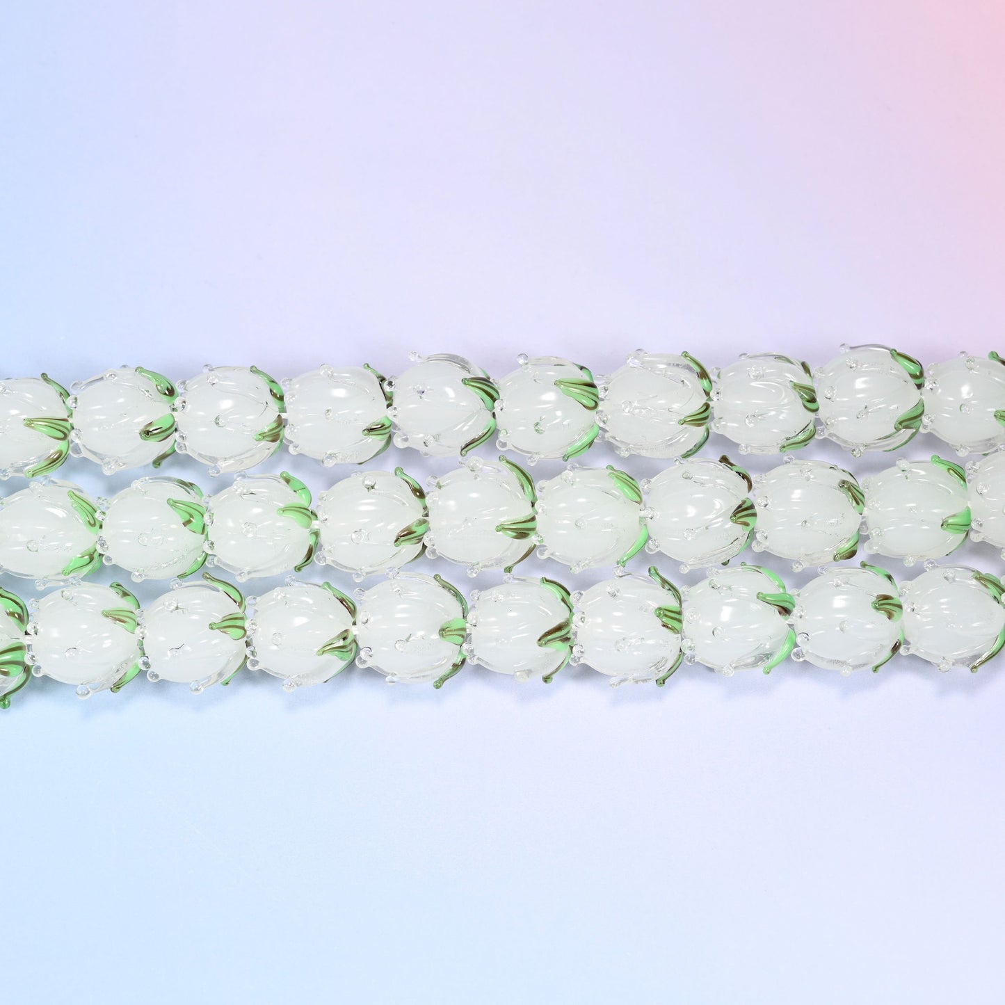 Tulip flower bud lampwork glass beads in frosted white with green leaf detail