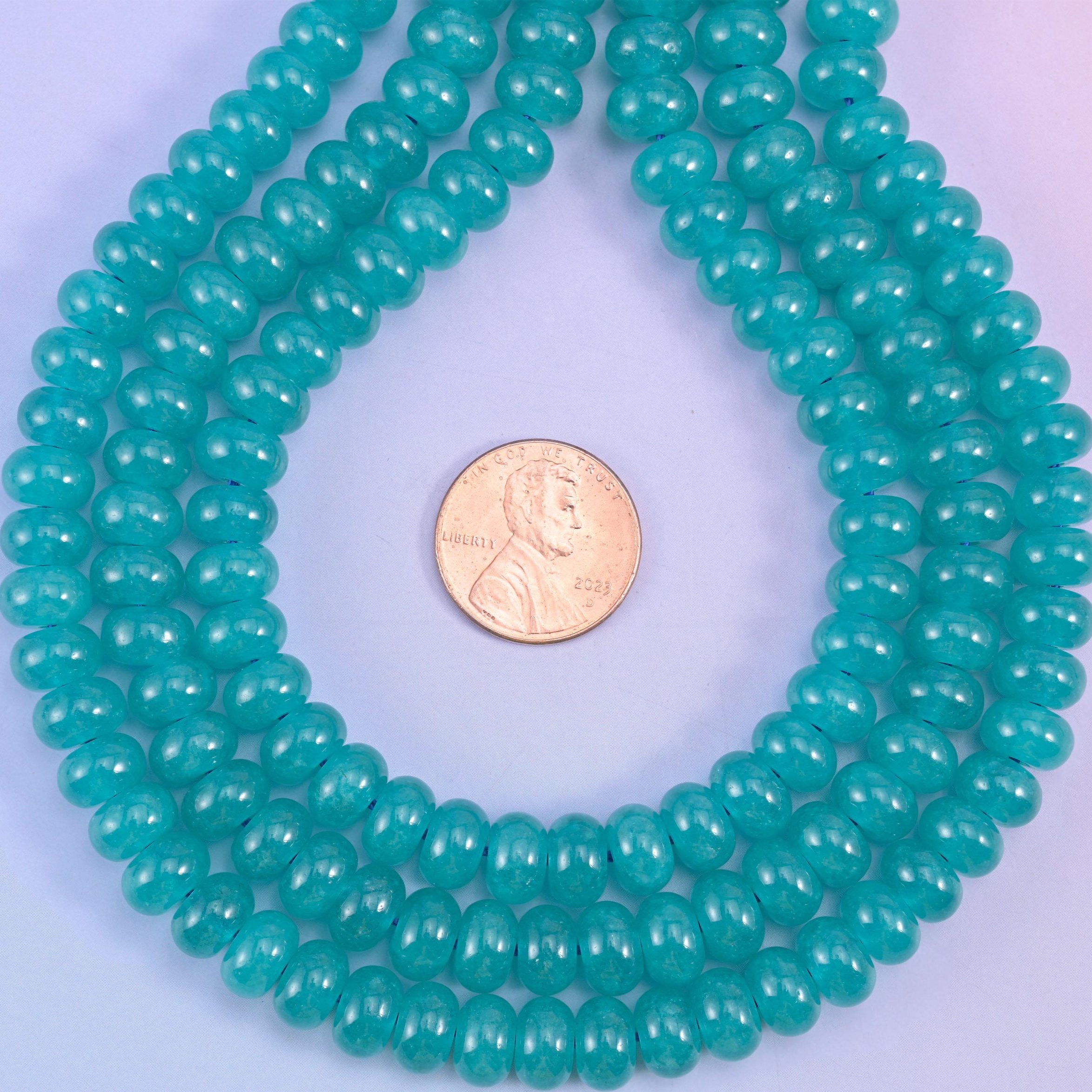Teal Dyed Jade smooth rondelle beads in a rich aqua-teal hue, finished with a smooth, polished surface