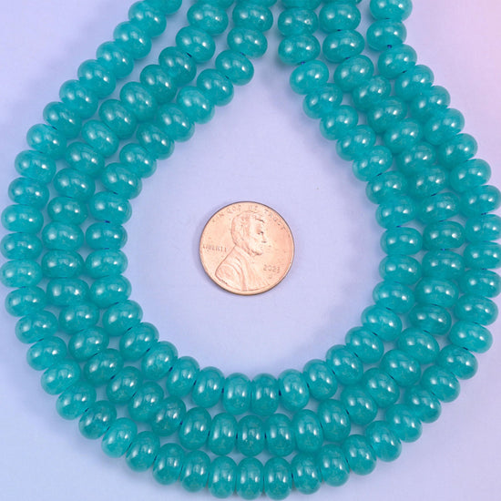 Teal Dyed Jade smooth rondelle beads in a rich aqua-teal hue, finished with a smooth, polished surface