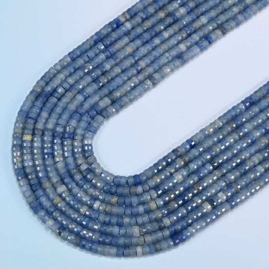 Blue aventurine faceted heishi disc beads in several strands curved into a wide U, light blue stone with a fine shimmer