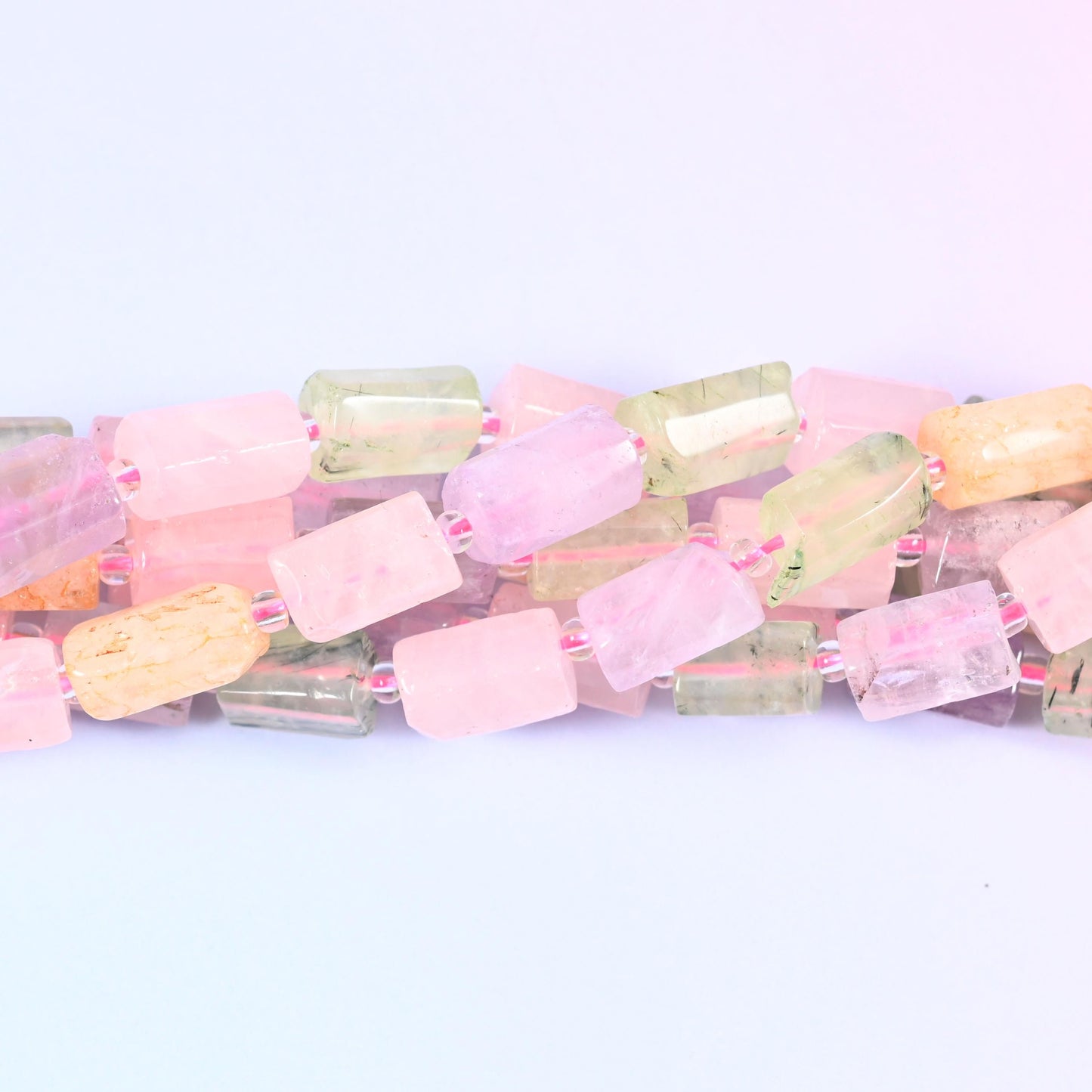 A blend of Rose Quartz, Prehnite, Light Amethyst and Citrine faceted tube cylinder beads in a sleek, modern shape