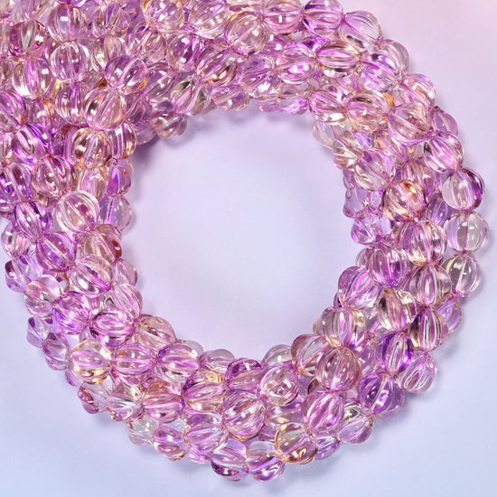 Clear purple gold pumpkin glass beads coiled into a densely packed ring with a small round opening.