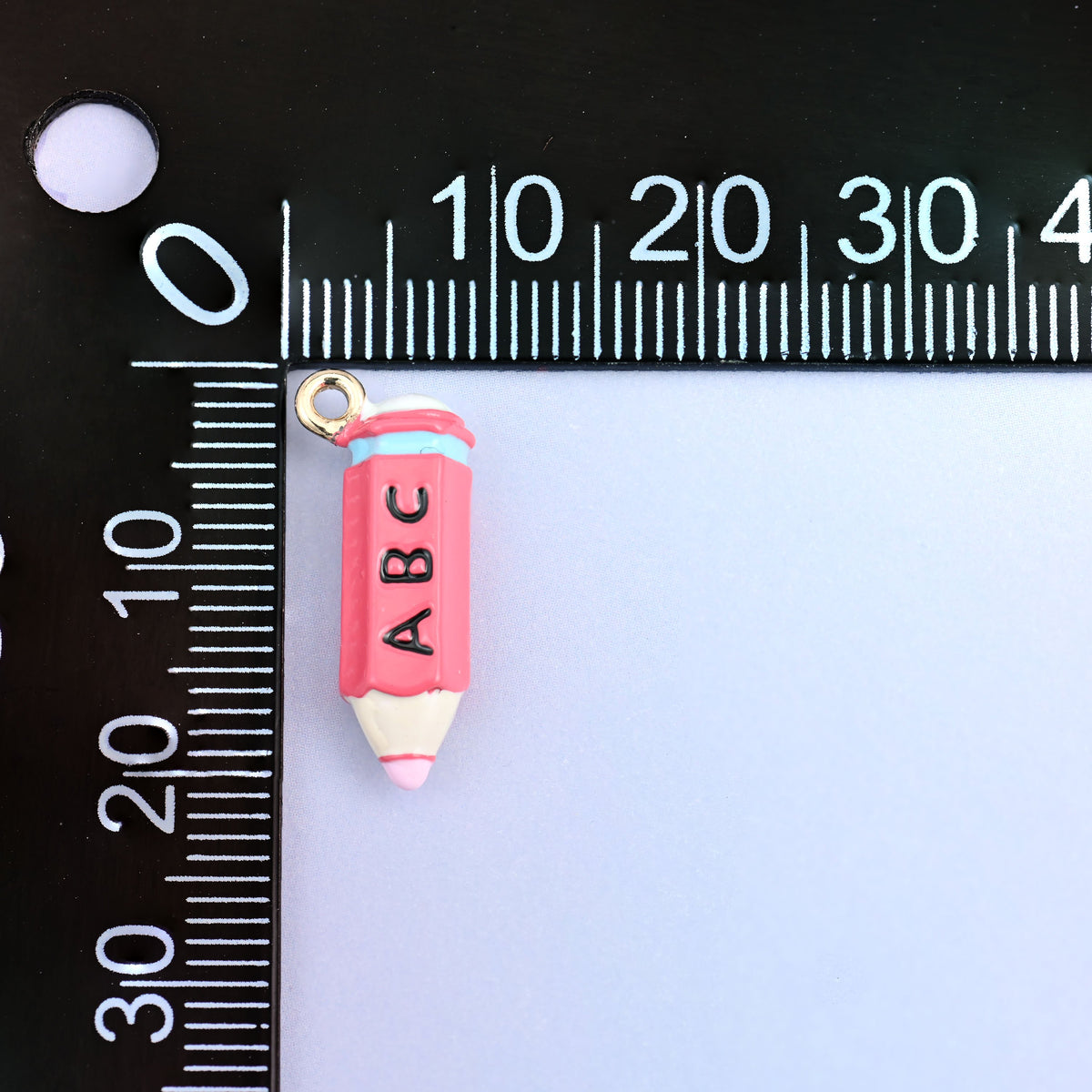 Pink pencil charm measured at 20.57 x 8.87mm including the small ring.