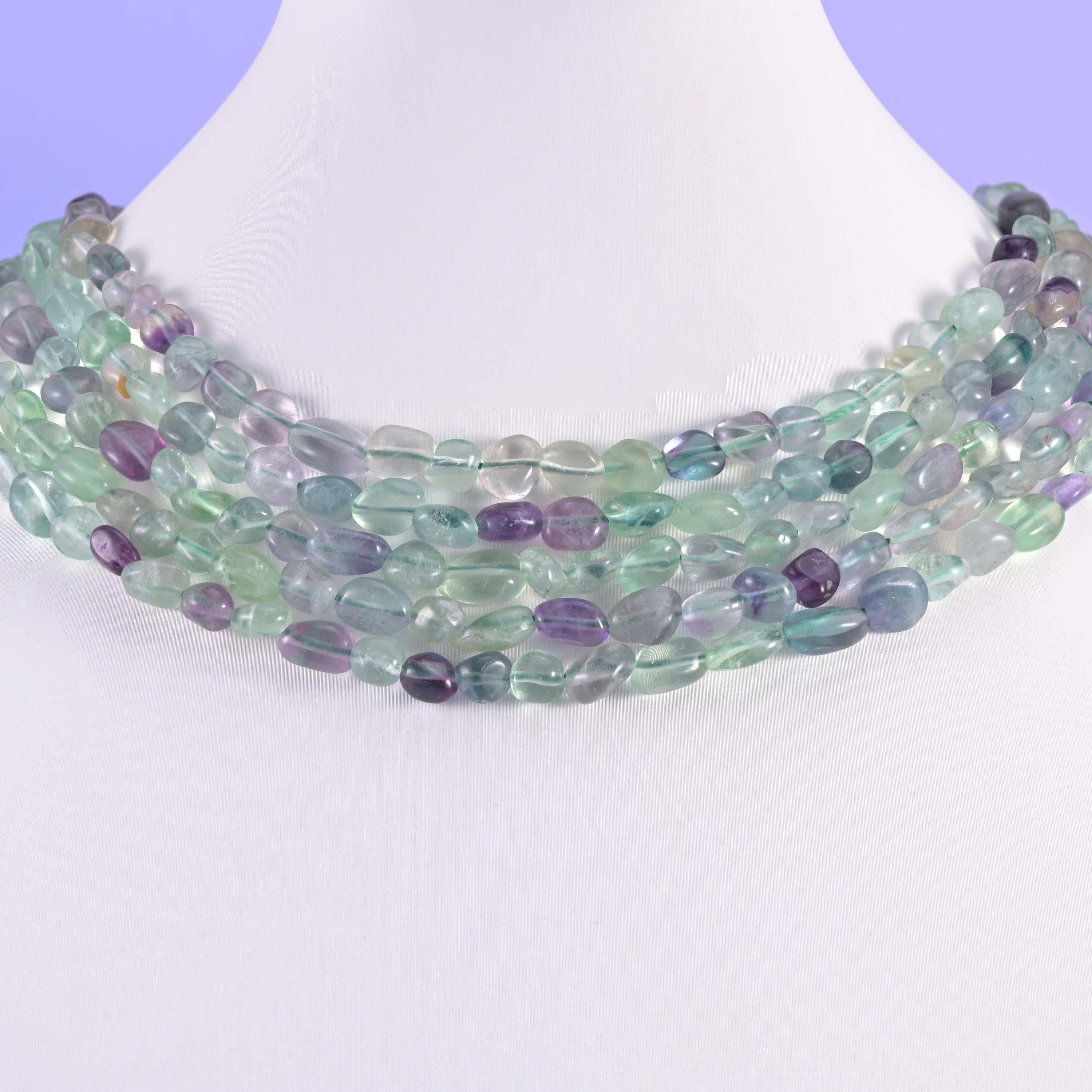 Fluorite pebble beads on a white display bust, worn as a layered collar