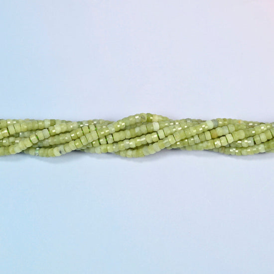 Strands of South Jade faceted heishi disc beads twisted together in a horizontal row