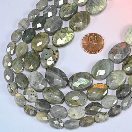 Gray Labradorite faceted oval beads in a deep loop, shown at their true size of 8x12mm to 15x20mm