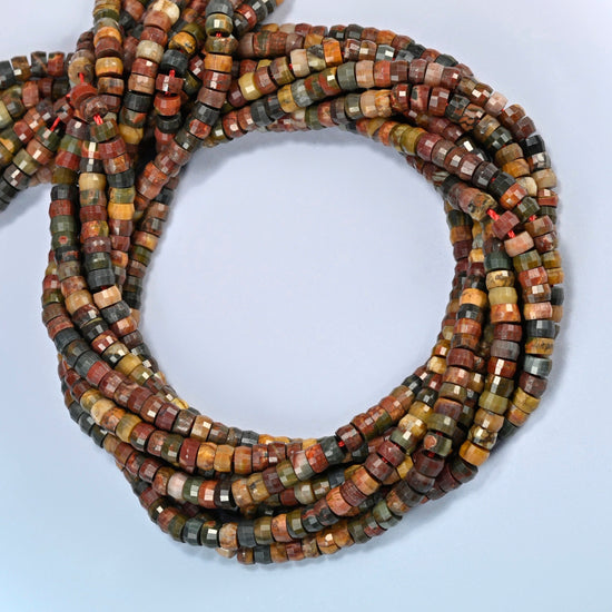 Red howlite faceted heishi disc beads coiled into overlapping loops, whole strands of earthy multicolor stone