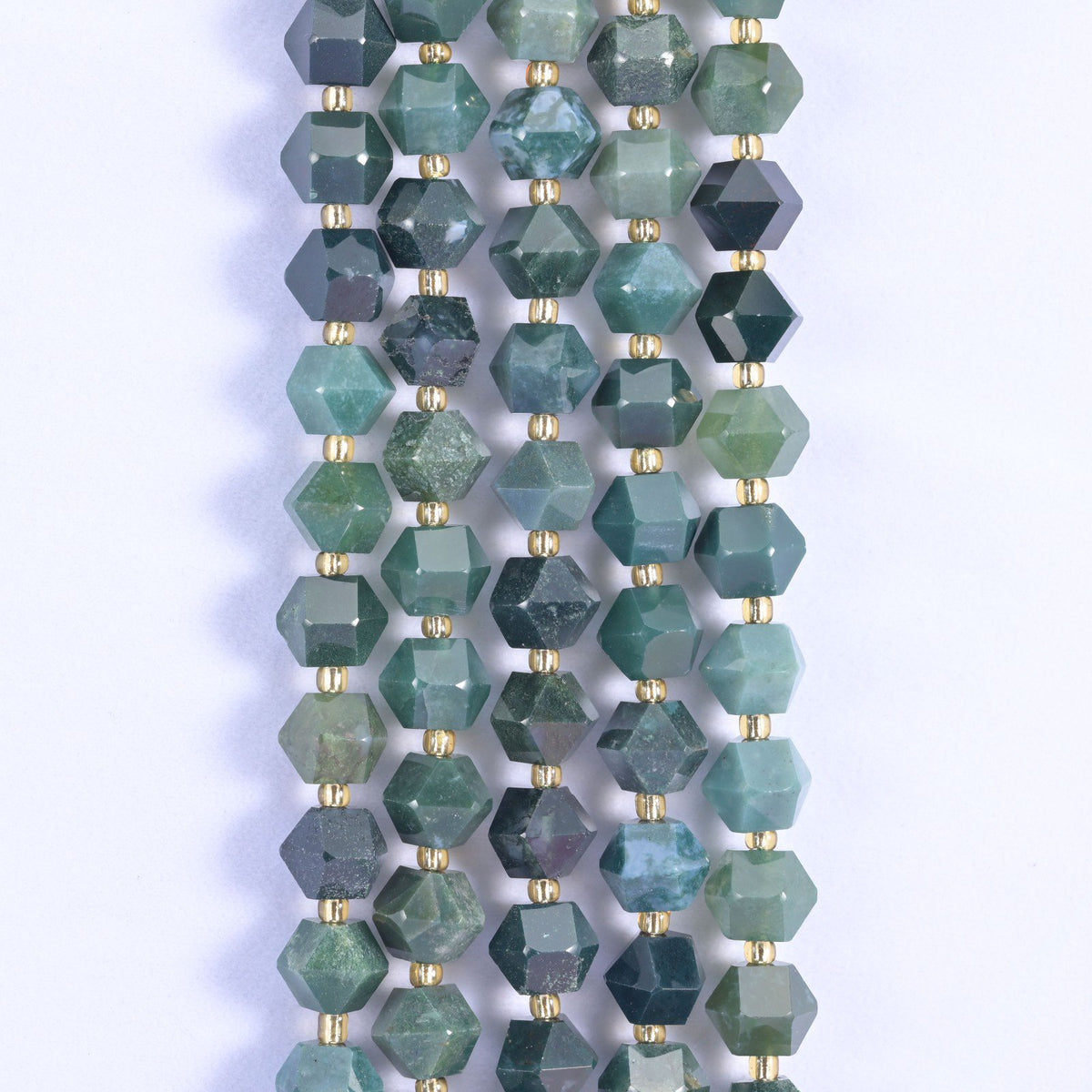 Faceted 8 sides diamond rhombus beads in moss agate in vertical rows, green moss threading through each bead.
