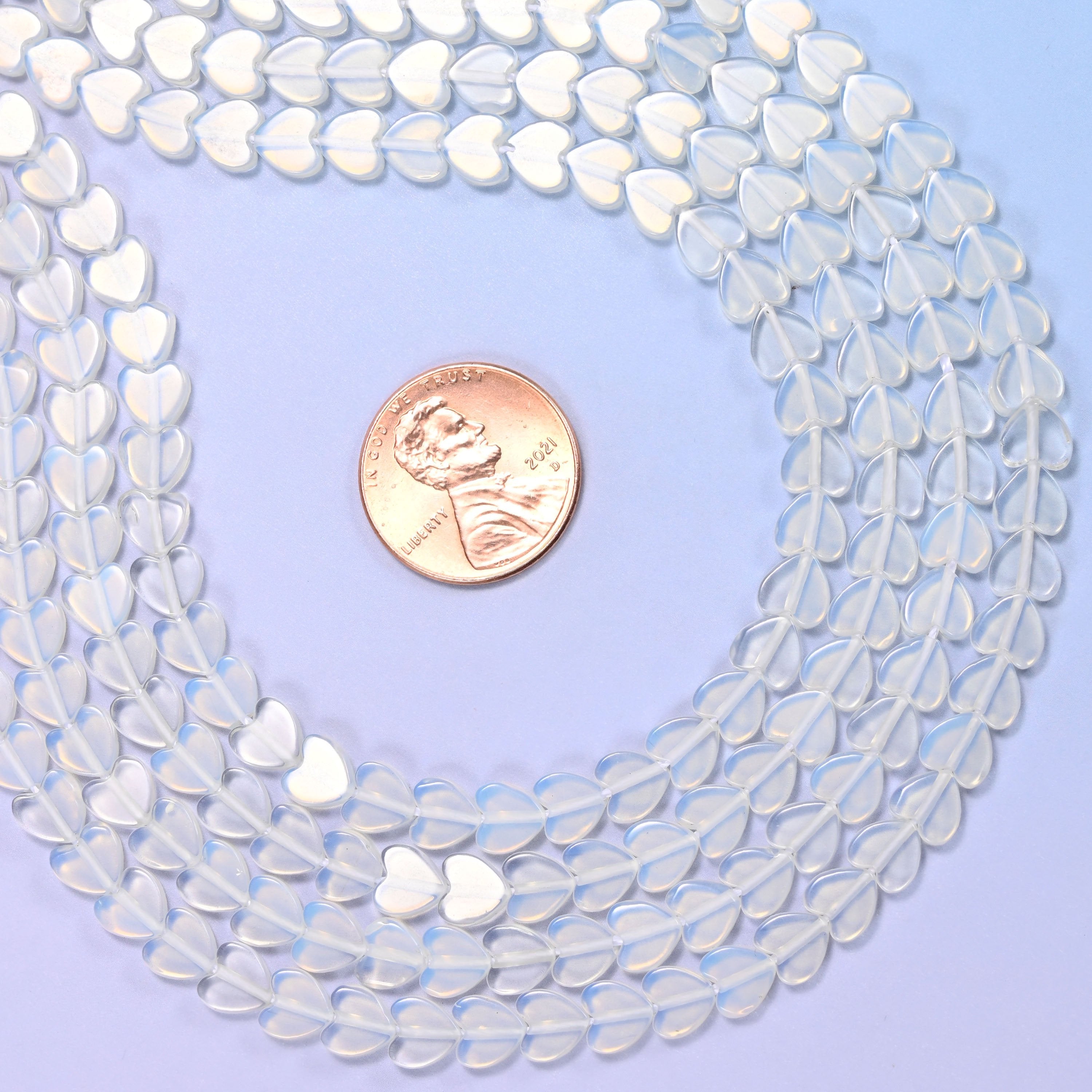 Opalite Flat Heart Beads, small flat hearts in milky white man-made glass with a blue opalescent glow
