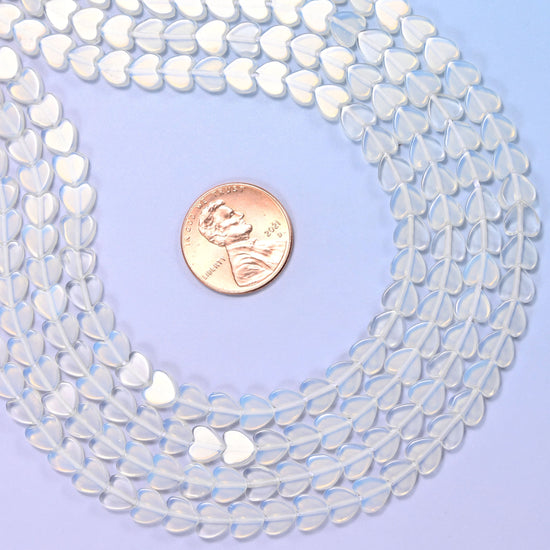 Opalite Flat Heart Beads, small flat hearts in milky white man-made glass with a blue opalescent glow