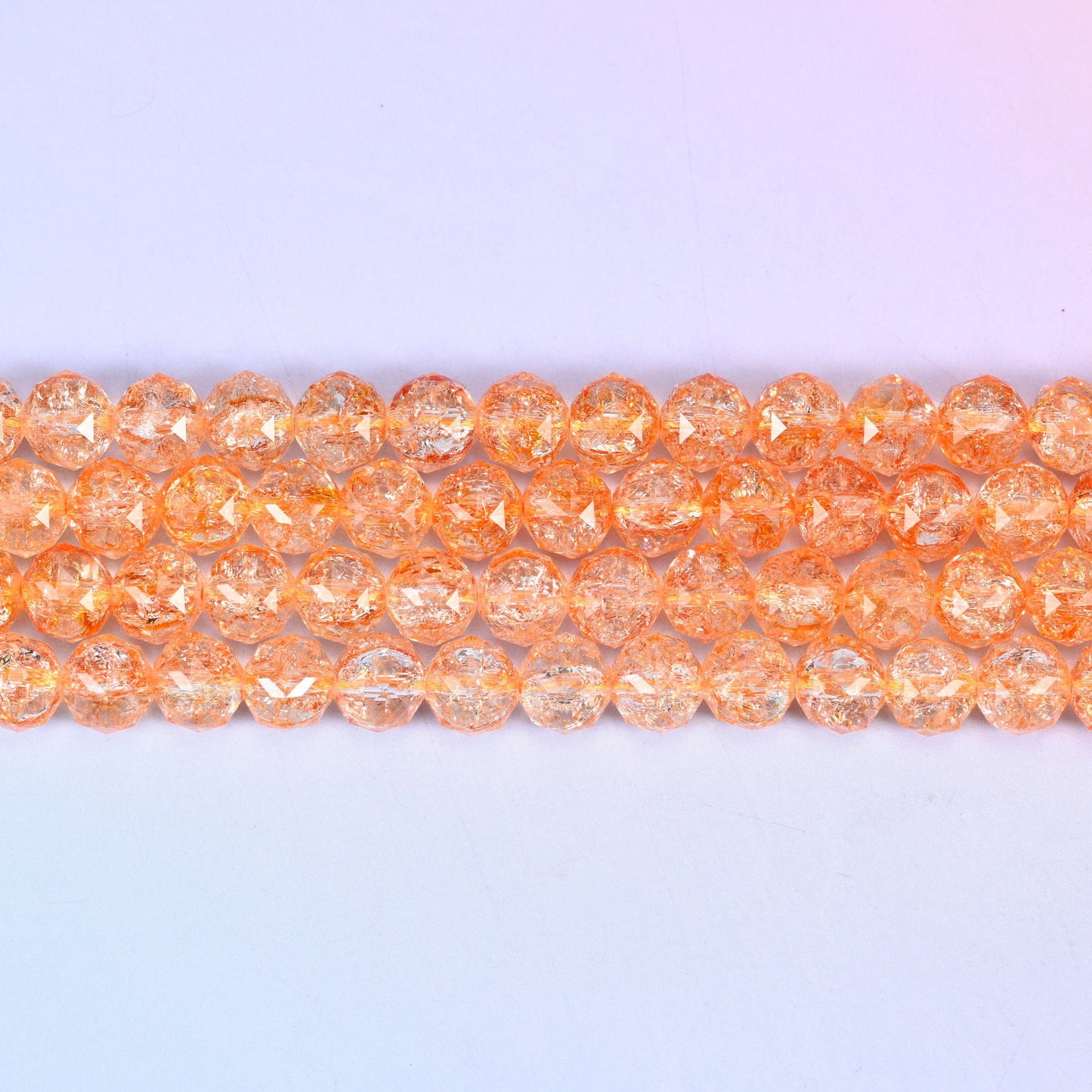 Transparent orange faceted round glass beads in soft apricot-orange