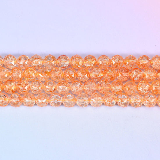 Transparent orange faceted round glass beads in soft apricot-orange