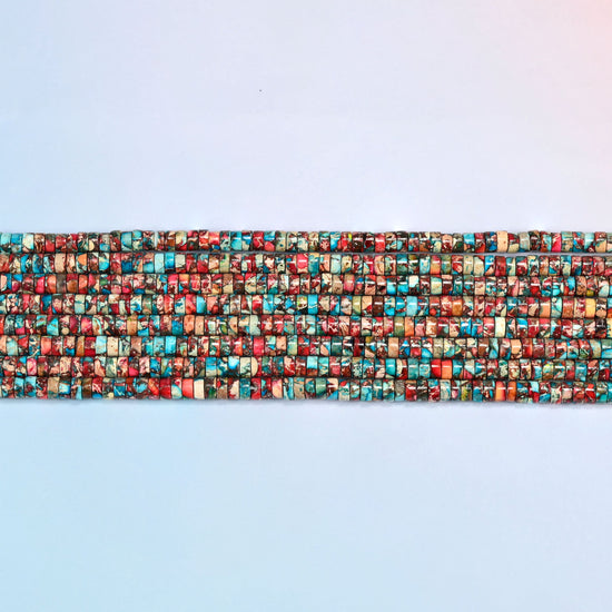 Several strands of dyed red blue sea sediment jasper heishi disc beads 2x4mm laid in straight rows, turquoise and red discs side by side