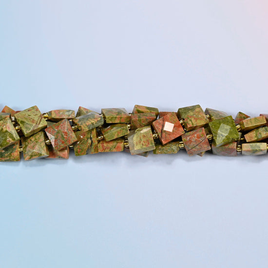 Strands of natural unakite faceted flat square beads twisted together in a horizontal row
