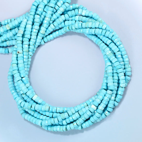 Dyed blue howlite faceted heishi disc beads coiled into overlapping loops, whole strands of bright turquoise stone