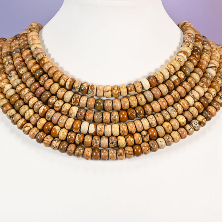 Multi-strand Picture Jasper necklace laid flat on a mannequin neck form against a lavender background.