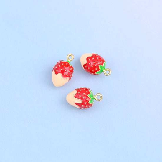 Three strawberry charms dipped in light orange enamel, green leaf and small gold ring at the top.