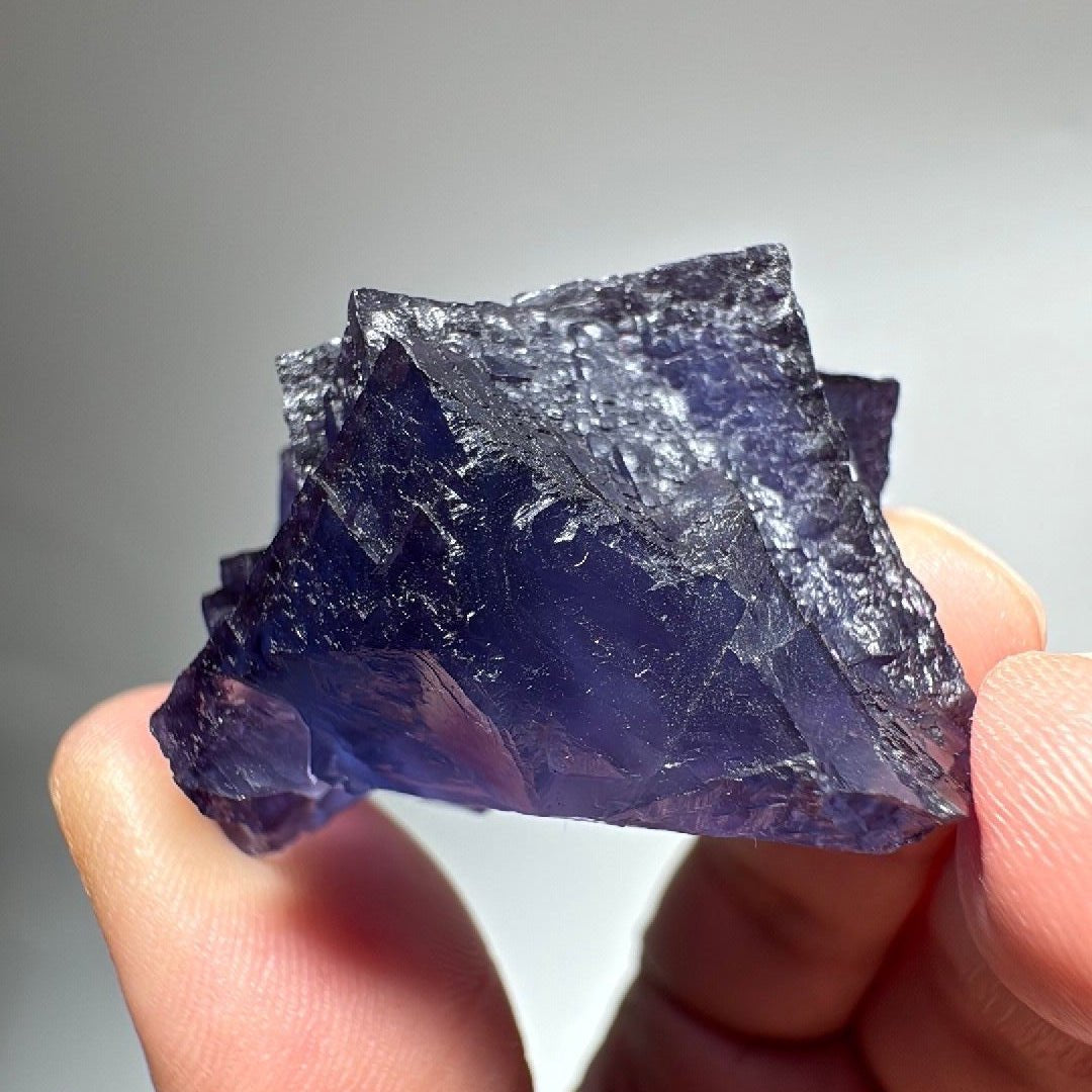 Purple blue Fluorite specimen with a small tan-brown patch on one side, mined in China