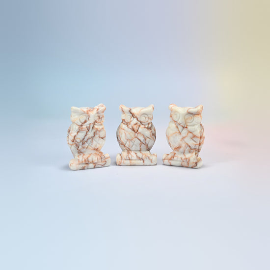 Owl crystal carving in red web jasper, cream natural stone with red web veining