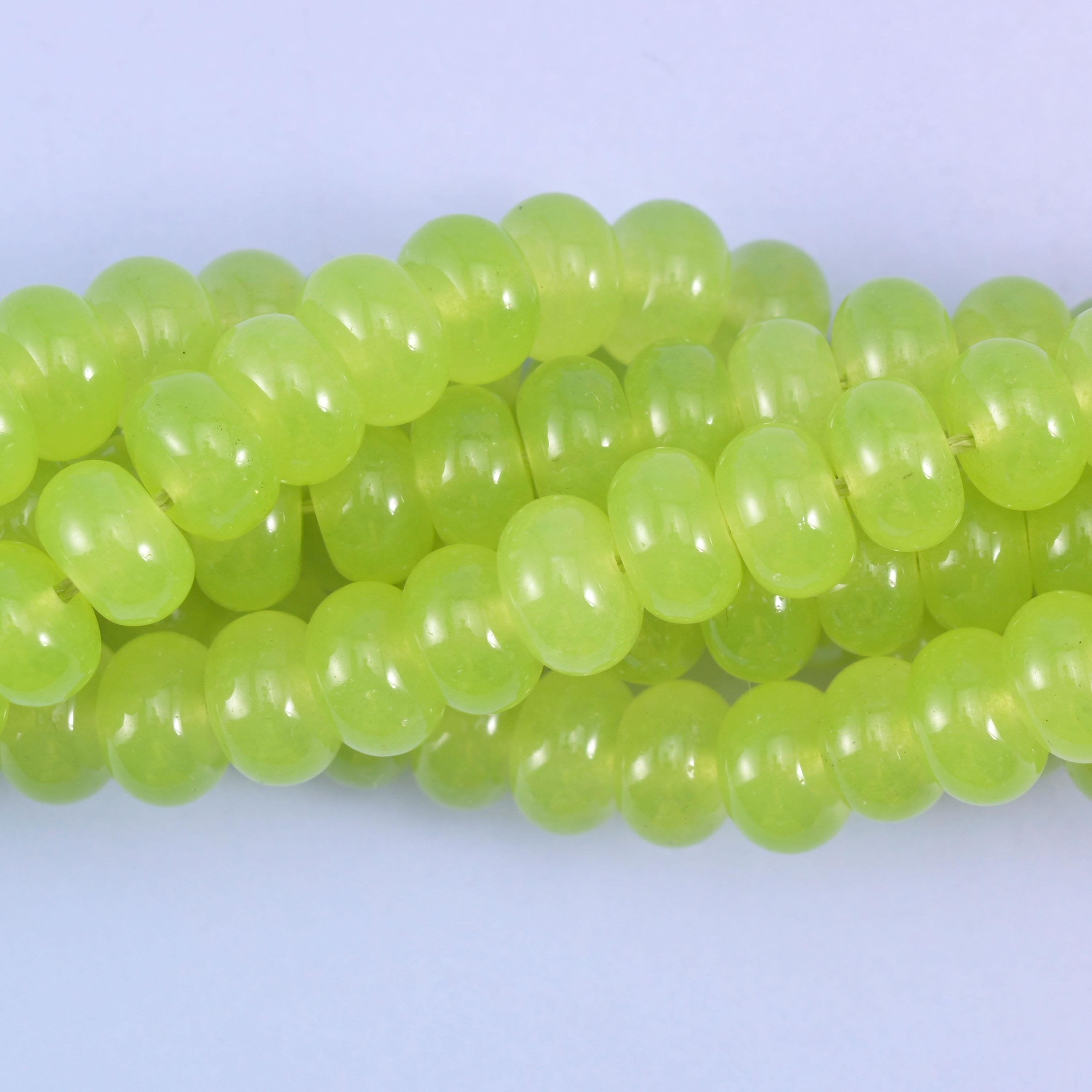 Smooth rondelle cut dyed jade beads with a polished surface