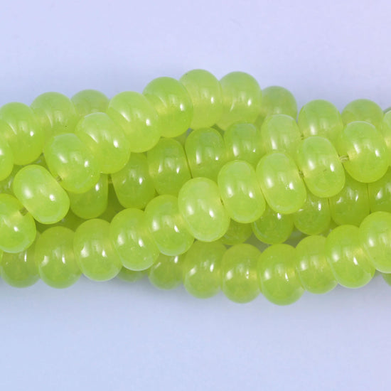 Smooth rondelle cut dyed jade beads with a polished surface