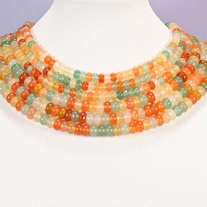 Gold Silk Jade gemstone rondelle beads laid in graduated collar rows, showing 4x6mm and 5x8mm side by side