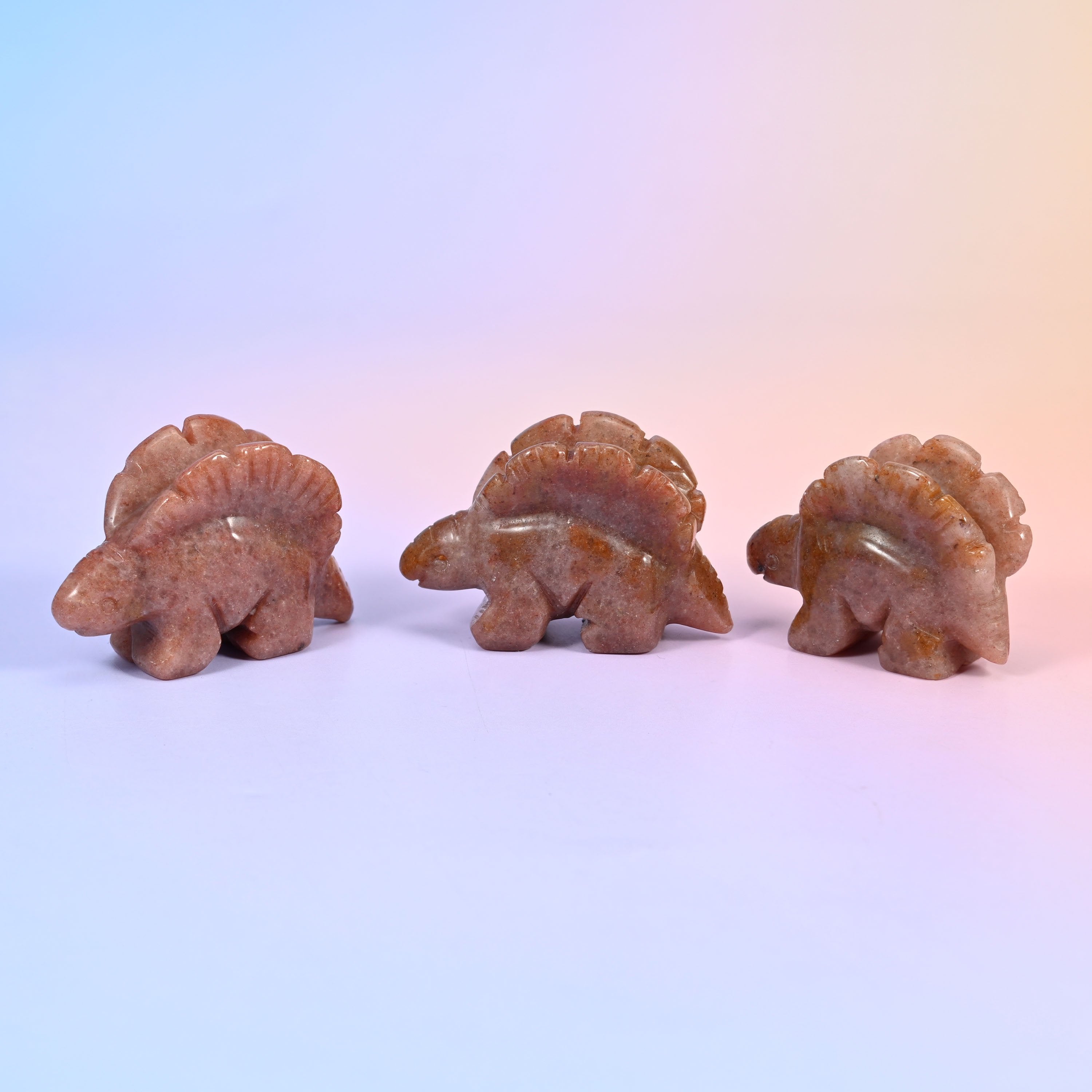 Stegosaurus carving offered in 12 natural stone options, from mint green and brick red to banded brown
