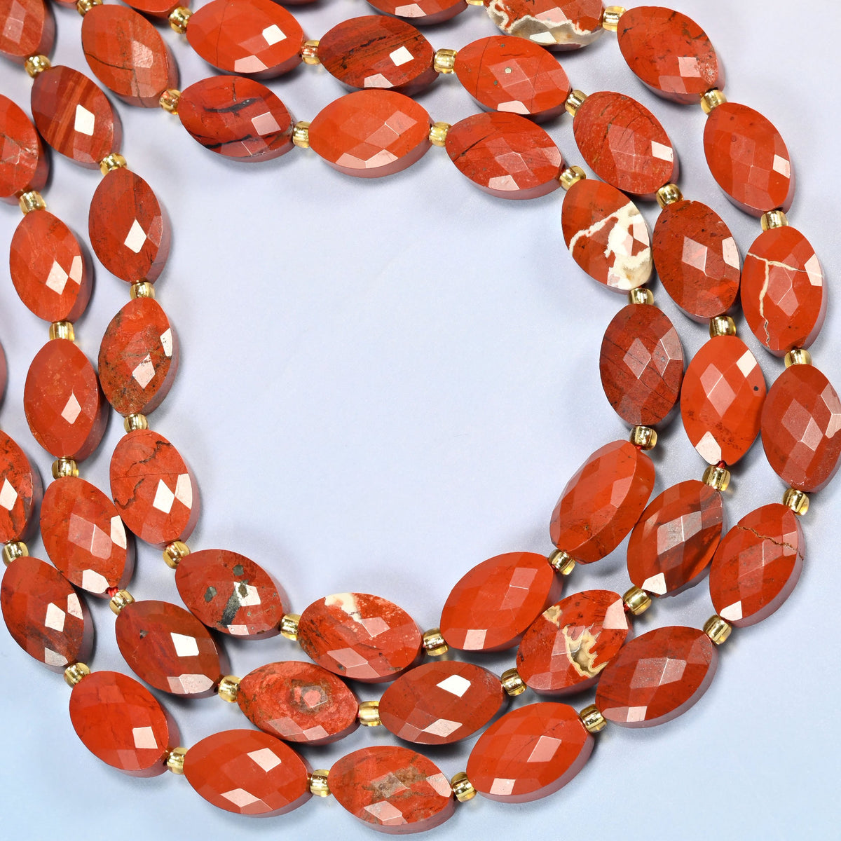 Flower red jasper faceted flat oval beads curved into an open loop, red stone with cream flower patches