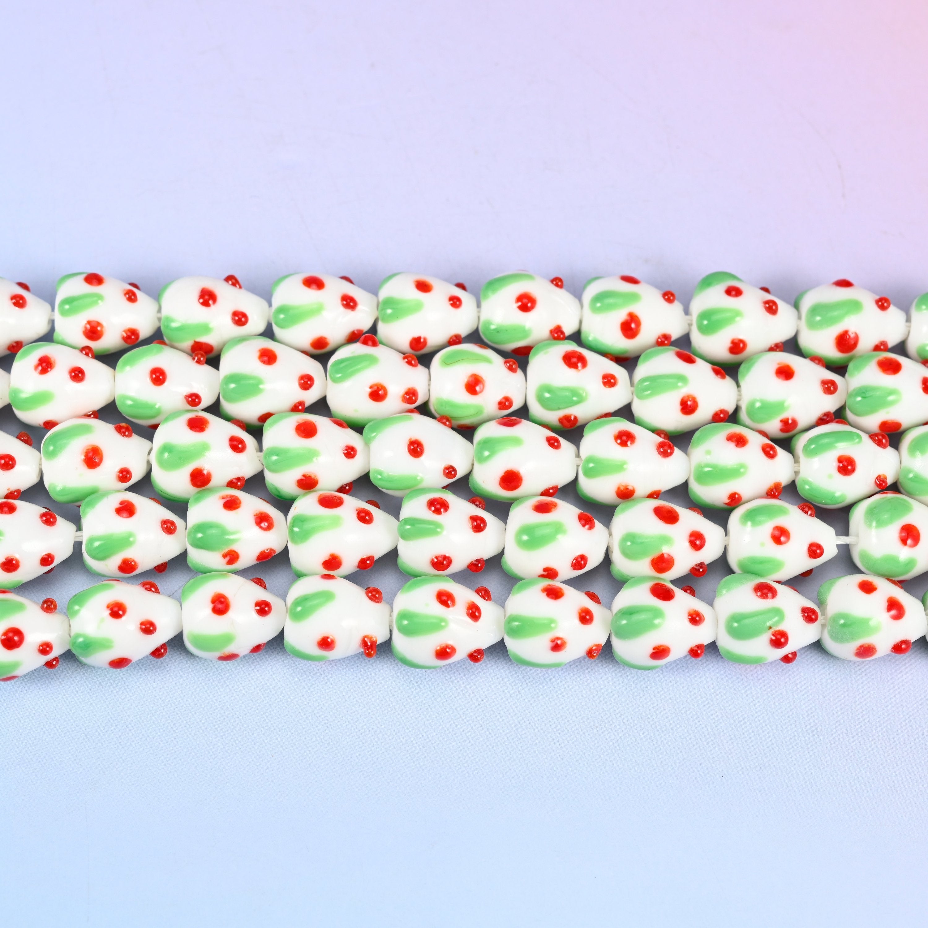 White Red Dots Strawberry Glass Beads in opaque white with a green leafy cap