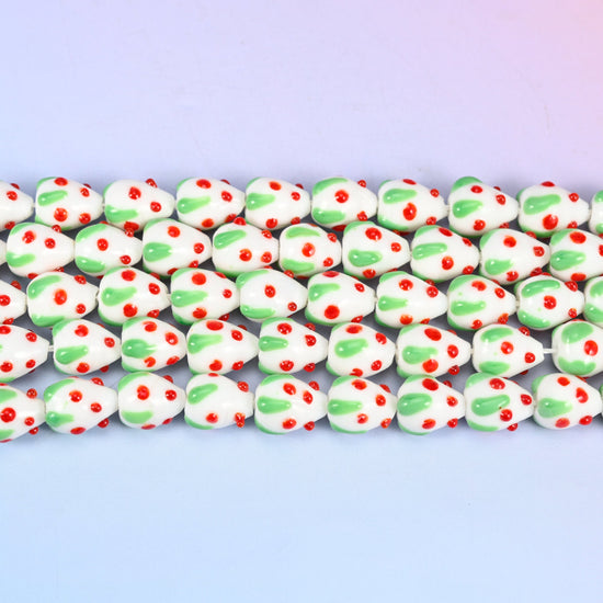 White Red Dots Strawberry Glass Beads in opaque white with a green leafy cap