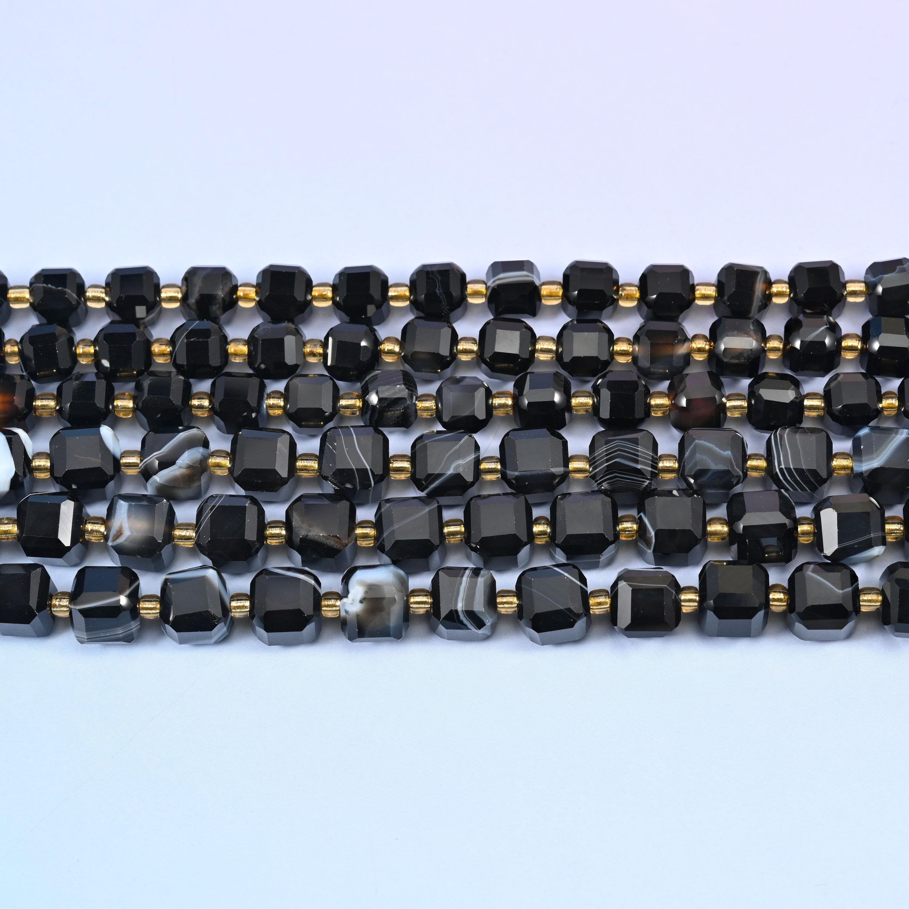 Dyed black strip agate faceted cube beads in deep glossy black with white and grey banding
