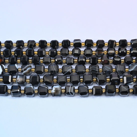Dyed black strip agate faceted cube beads in deep glossy black with white and grey banding