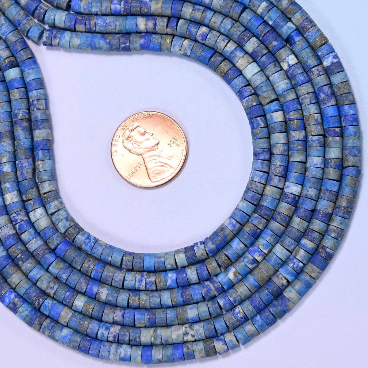 Natural lapis lazuli matte heishi disc beads in a rich, striking deep blue with a sophisticated matte finish.