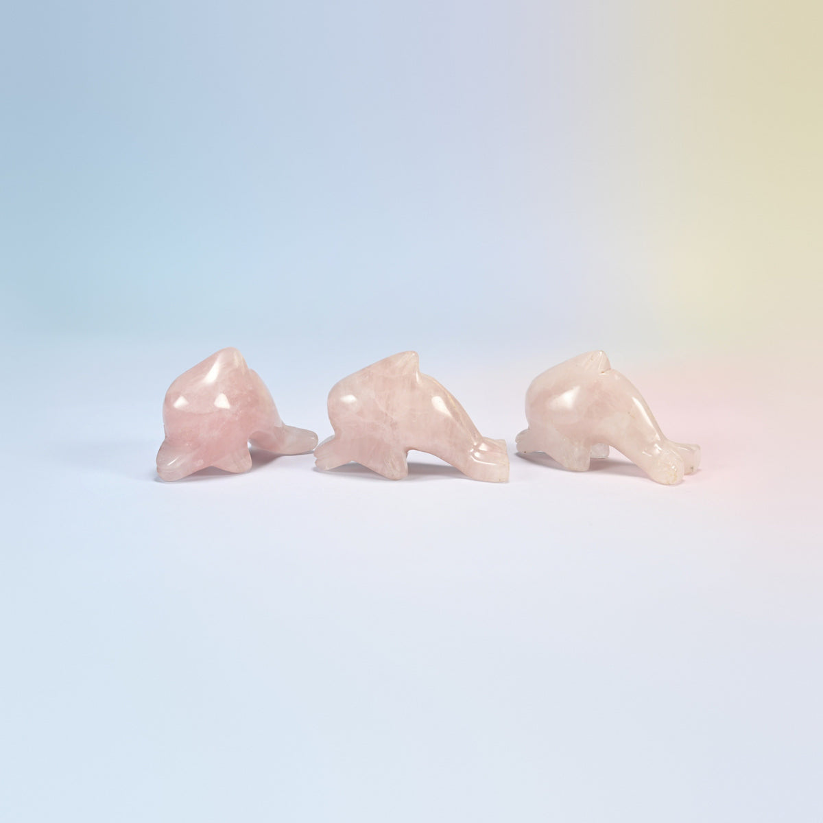 Three rose quartz dolphin crystal carvings, 2 inch, light pink natural stone
