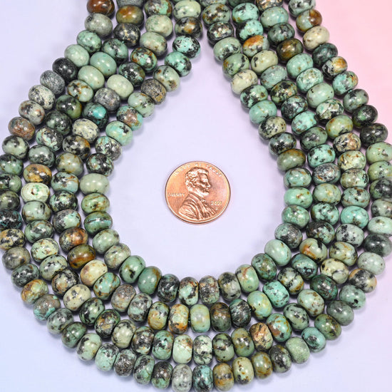 Close-up of coiled African Howlite beads showing the natural texture and black matrix veining.
